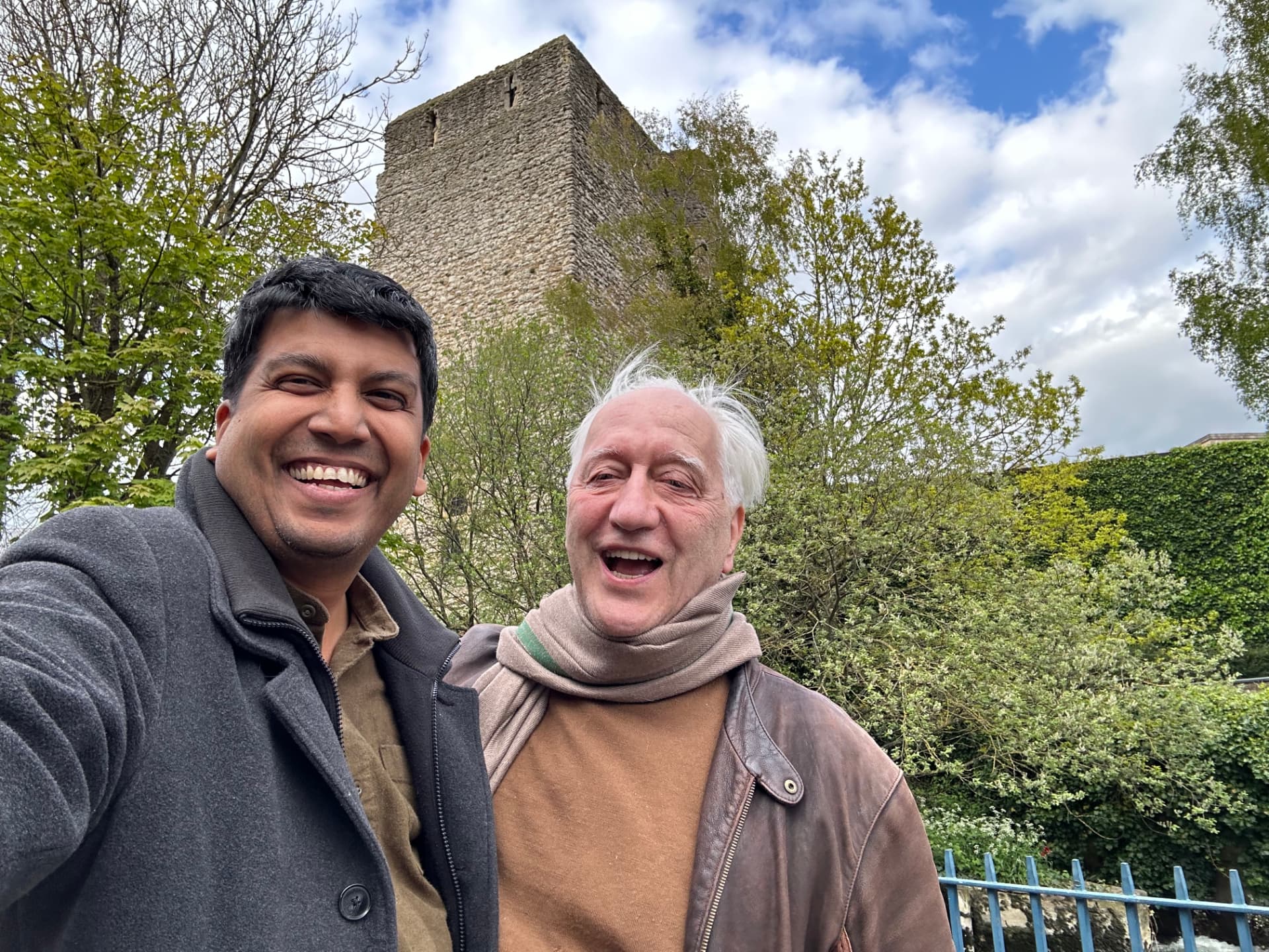 Charles Landry and Anupam Yog outdoors beneath a stone tower — Festival President and Festival Director of The Art of Citymaking