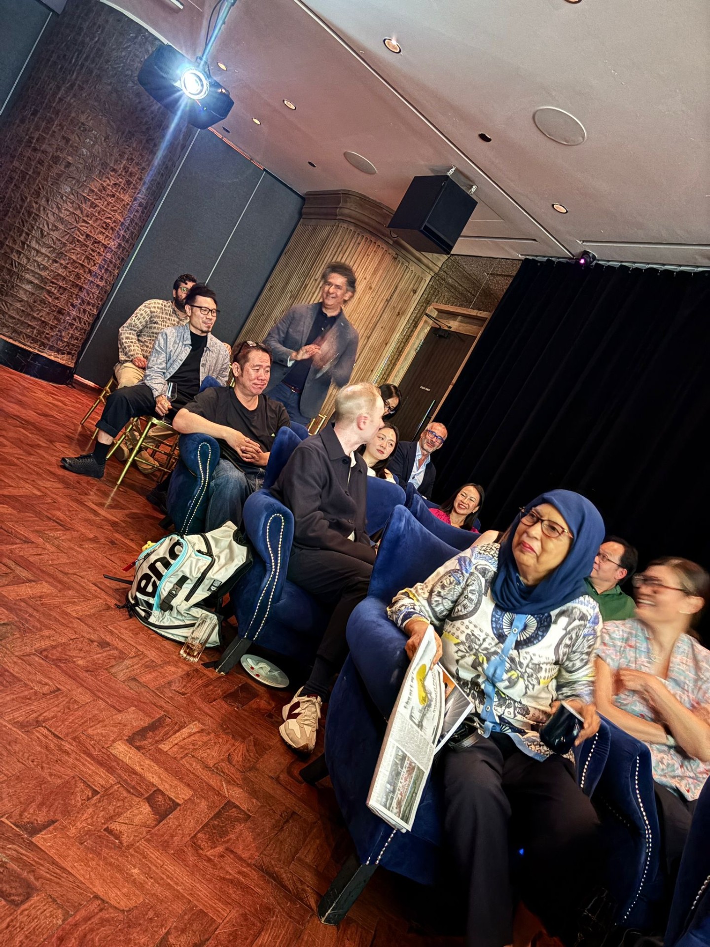 The audience in blue velvet chairs at The Nanson