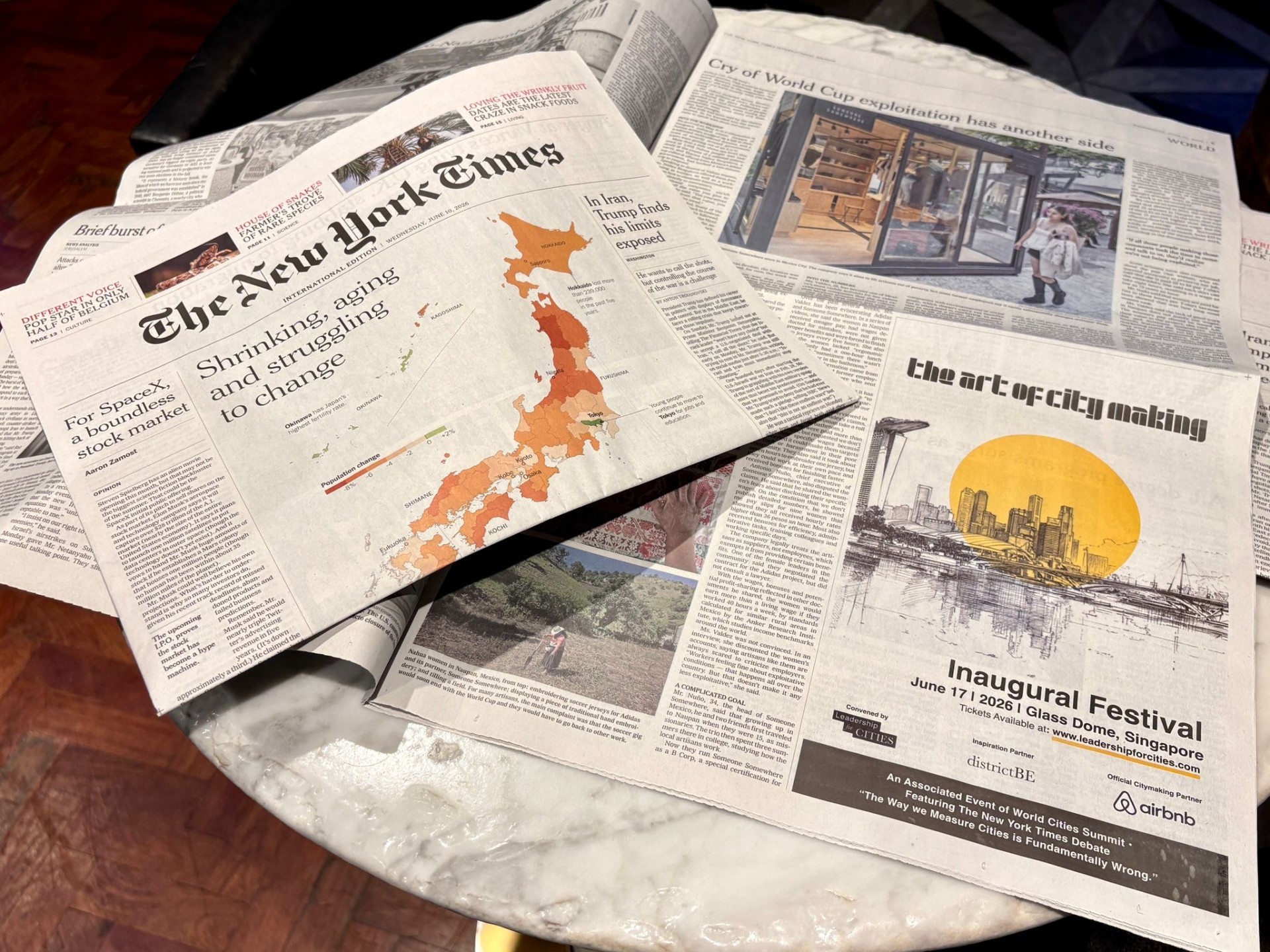 A quarter-page Festival ad in the New York Times International Edition, beside the morning's front page