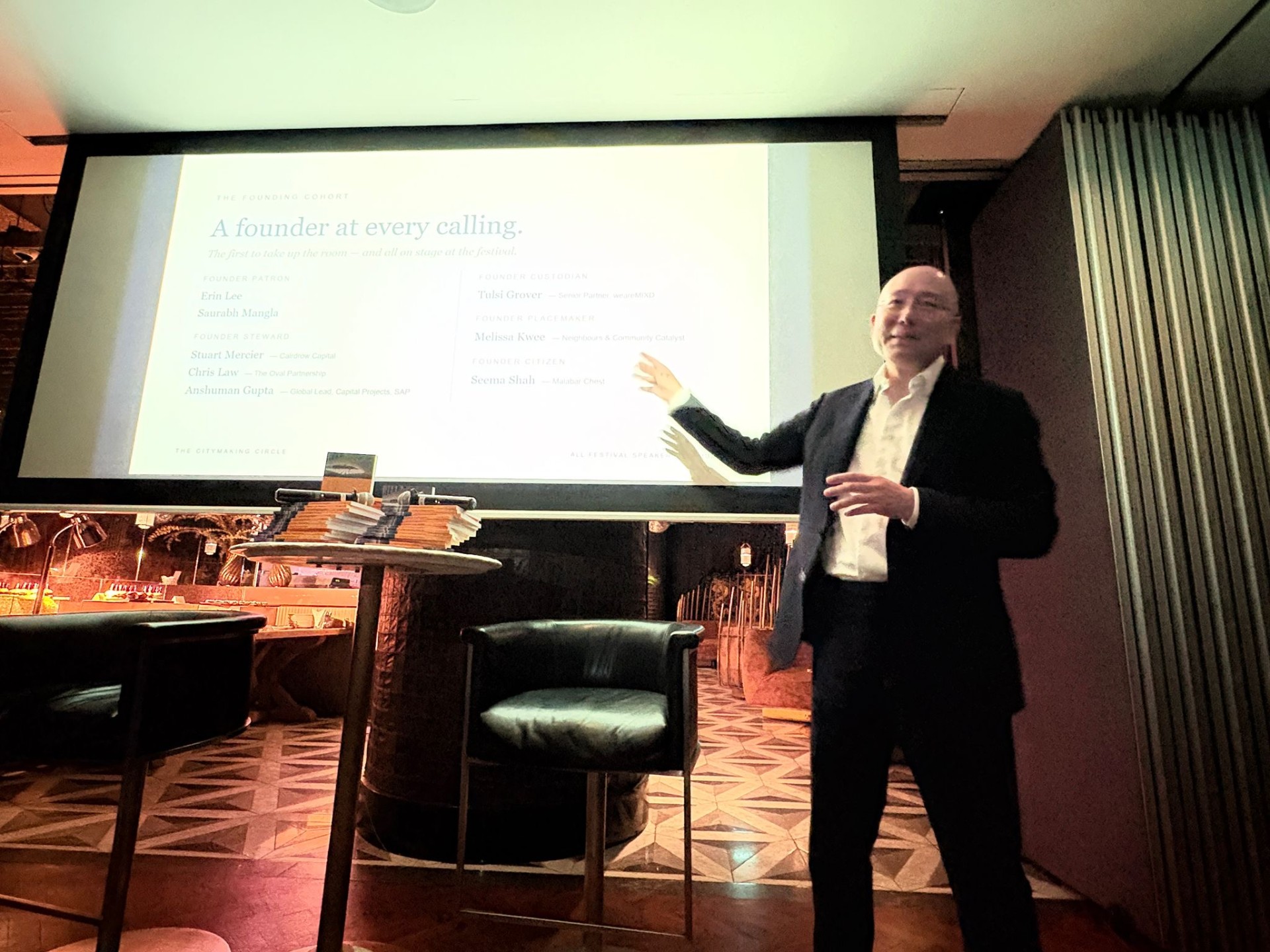 A speaker presenting the founding cohort slide at The Nanson