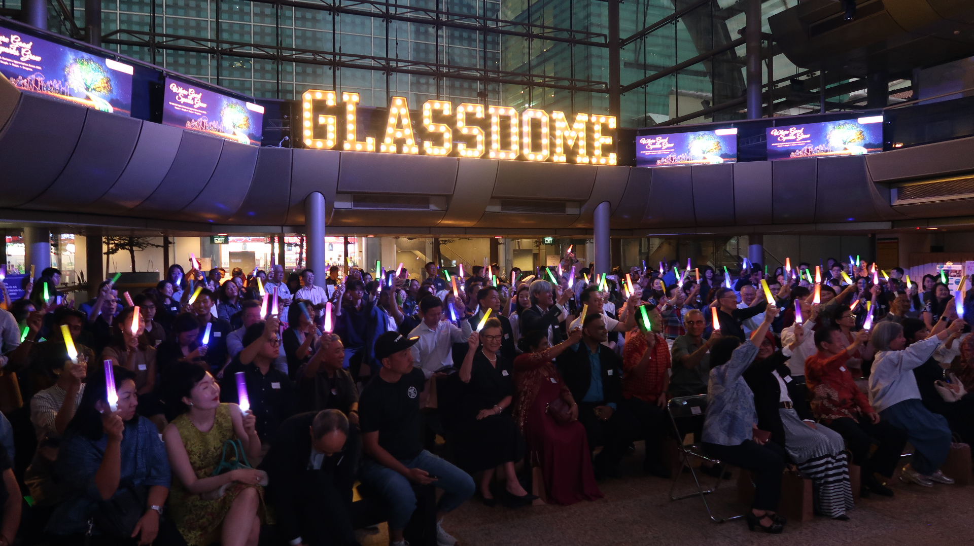 GlassDome, Singapore — a full-house evening audience under the illuminated GlassDome marquee